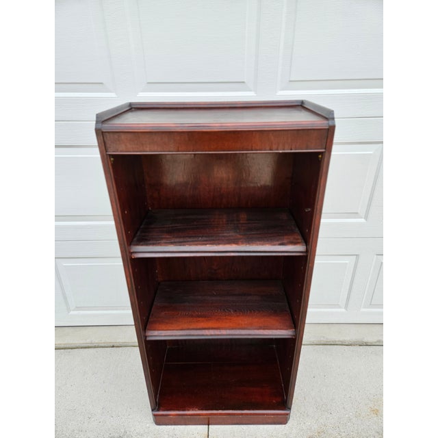 A solidly built mahogany bookcase with four adjustable shelves. This piece has a nice lip around the back and sides of the...