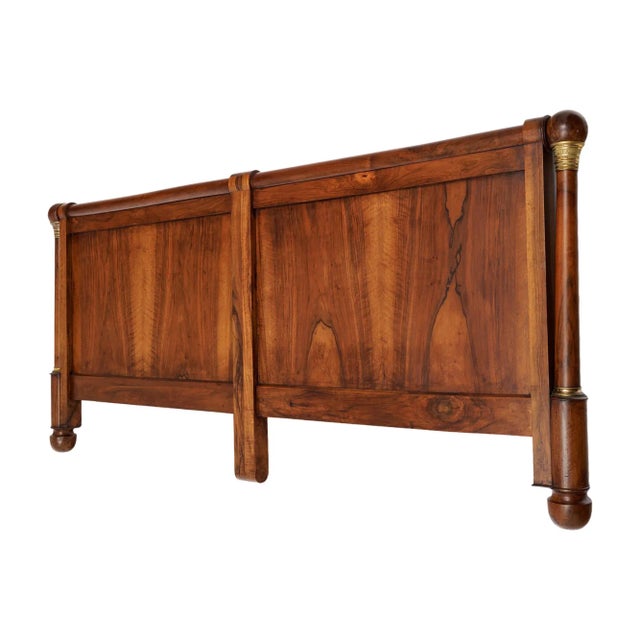 Grand French headboard from the 19th century made of solid wood construction; primarily walnut. This piece has bronze...