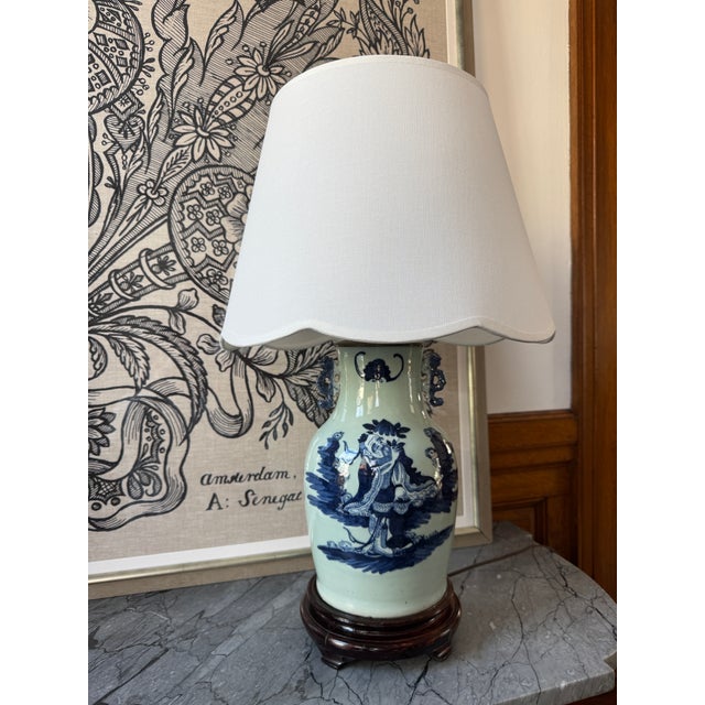 Antique Chinese celadon glazed lamp with hand painted design. Vase converted to a lamp with lion-style handles and...