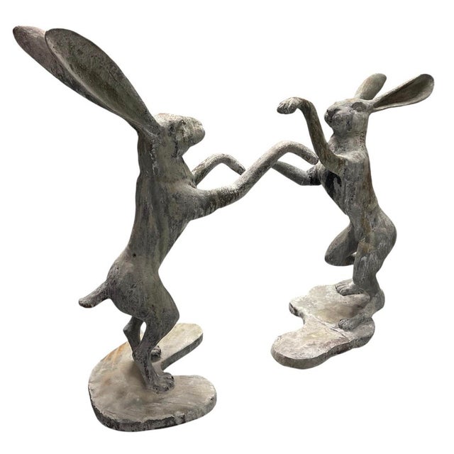 This pair of vintage cast iron "boxing hares" statues. Crafted with exceptional detail and realism, these heavy-cast...