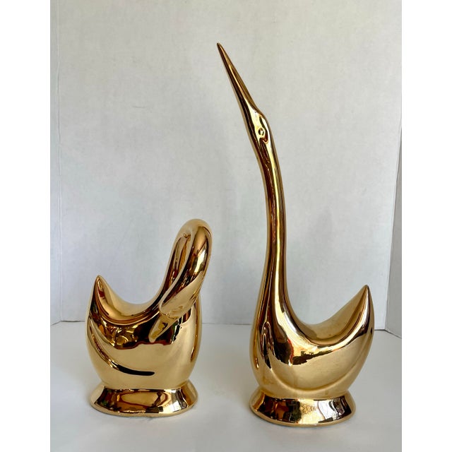 Here is a gorgeous pair of porcelain ceramic swan figurines that are finished in a stunning 18k gold finish. The gold is...
