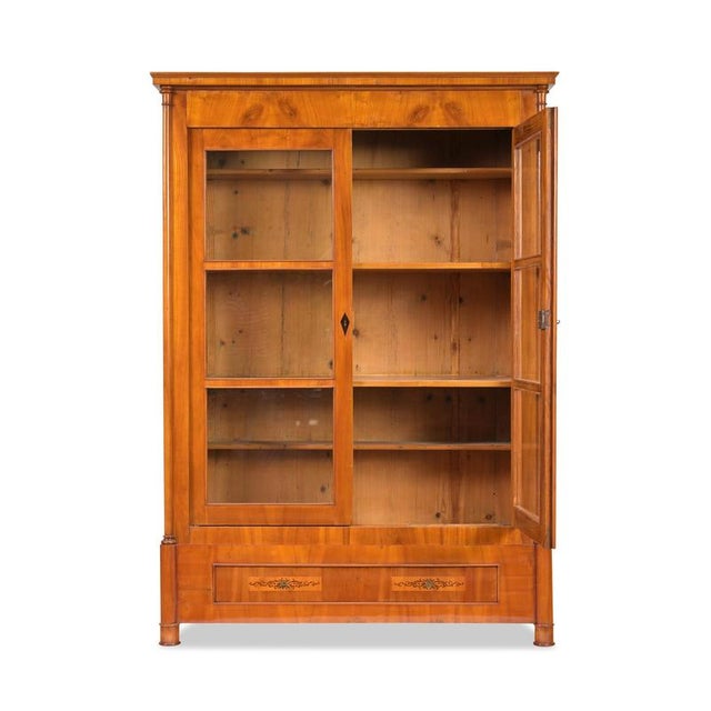 Biedermeier display cabinet, Southern Germany, circa 1800, cherry wood, two-part design with one drawer in the base,...