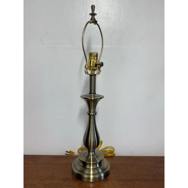 Vintage Stiffel solid brass table lamp with an elegant antique brass finish. Includes the original shade and finial....