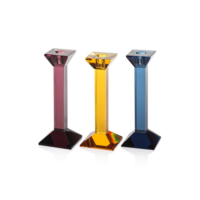The Carmac Colored Crystal Glass Taper Candle Holder is a stunning blend of classic design and modern elegance. Its square...