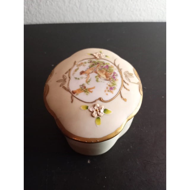This is a vintage Handpainted Porcelain 4" Trinket Dresser Box. Procured at auction