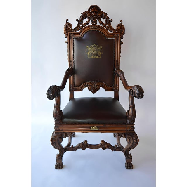 Impressive mid-19th century Italian Baroque style throne armchair, hand carved in walnut with dark leather upholstery. The...