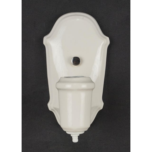Traditional white porcelain wall sconces with switches. Each sconce requires one Edison style medium base bulb. Good...
