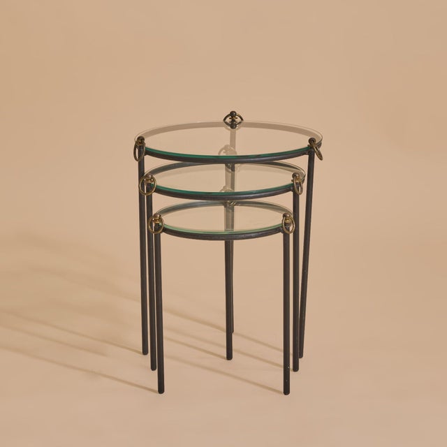 A trio of French round nesting tables by Jacques Adnet dating back to the 1950s, crafted in patinated metal with...