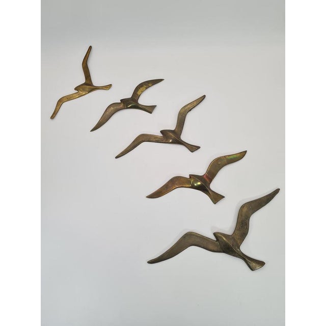 An impressive set of five wall decorations in the form of flying seagulls, made of brass. The dynamic, minimalist form...