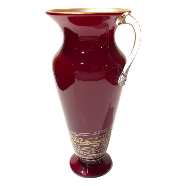 An elegant hand-blown studio glass vase by Rick Strini, an acclaimed American glass artist known for his refined forms and...