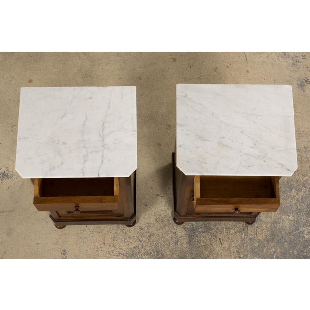 Pair of antique French nightstands crafted in the Louis Philippe style, dating to the late 19th century and sourced in...