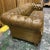 Details: Handsome vintage Chesterfield sofa upholstered in light whiskey brown leather. Features deep button tufting along...