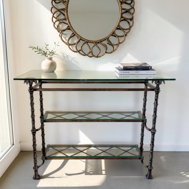 Elegant and distinctive, this vintage-inspired console table features a bronzed metal faux-bamboo frame accented by...