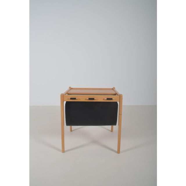 Mid-century side table with magazine holder designed by SP Jensen and manufactured by the Danish company BRDR Furbo. The...