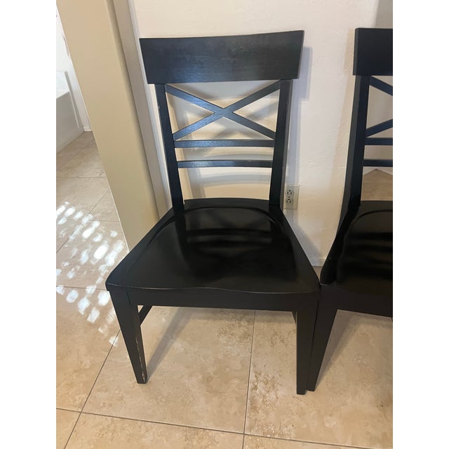 Solid black wood Blake Dining Chairs from Ethan Allen Furniture. The chairs combine farmhouse details with metropolitan...