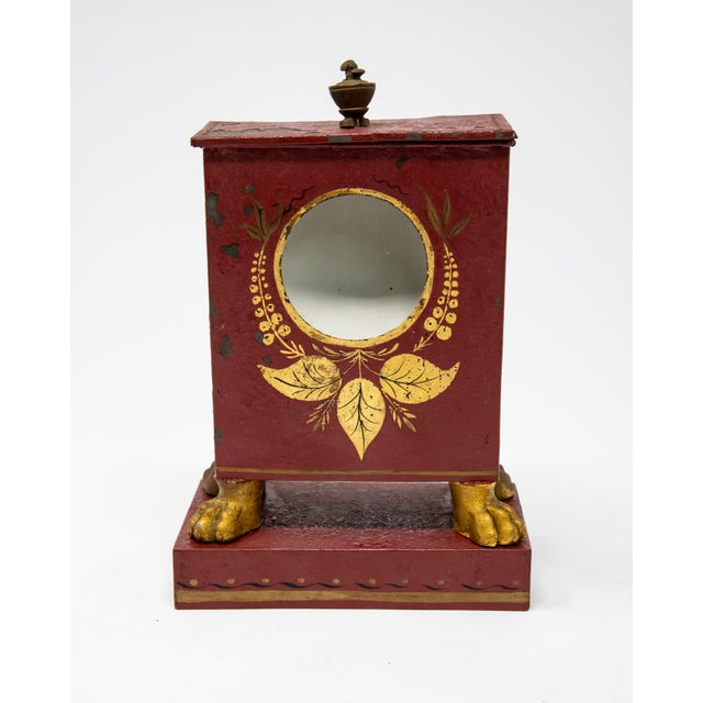 Offering this magnificent red and gold hand painted pocket watch safe. Starting on a geometrical rectangle bottom it has a...