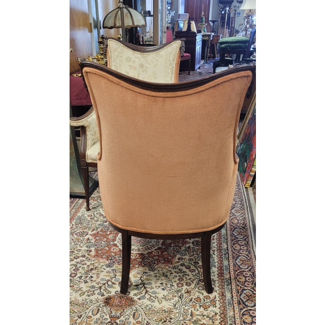 Fine elegant pair of 1940s fireside or parlor chairs. Each chair features two tone fabric with mauve velvety backs and...