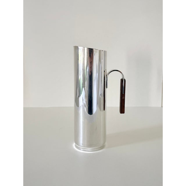 Cylindrical cocktail mixer and pitcher set, made in Italy circa 1950s. Made of silver-plated stainless steel with rosewood...