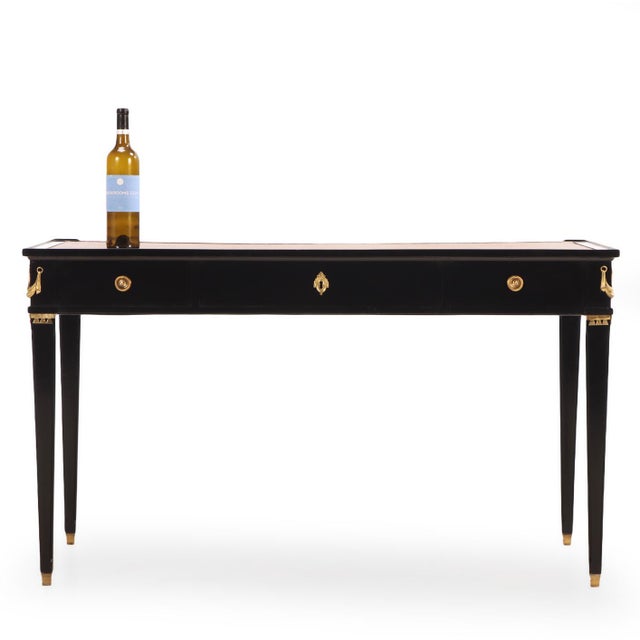 This Directoire-style writing desk features beautiful brass mounts with matching brass handles on each of its three...
