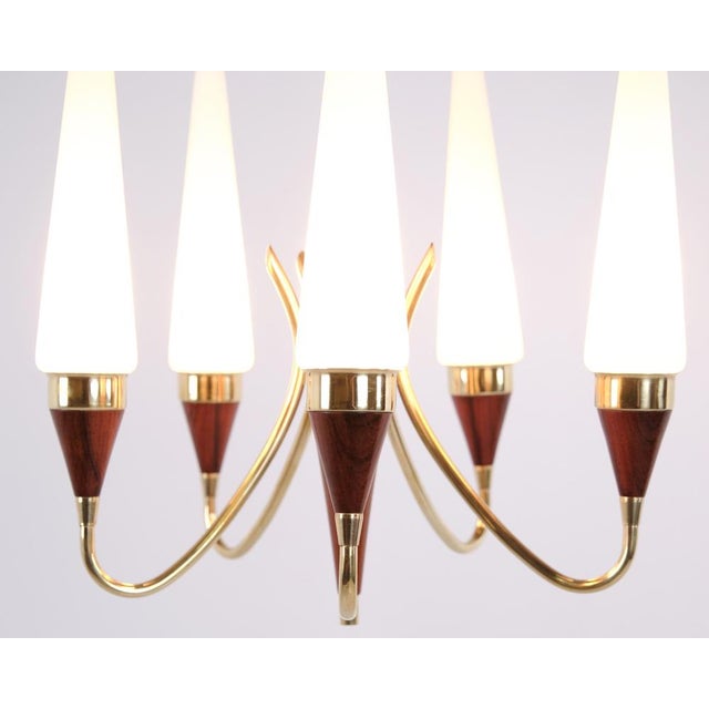 Five-arm chandelier designed by Bent Karlby and manufactured by Lyfa in the 1960s. The lamp features a brass and teak...