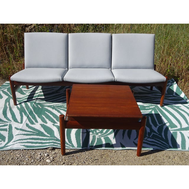 Teak lounge set comprising a three-seater sofa and a modular coffee table. Model Saga, Norwegian manufacture, 1960s, by...