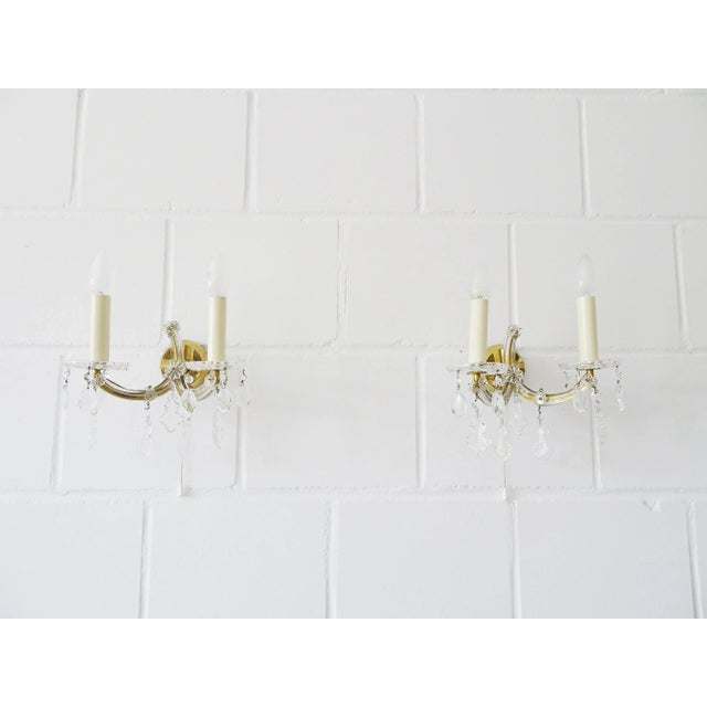 These two wall lamps in the Maria Theresia style, are 2 arm wall appliques made of crystal glass with pull switch. The...