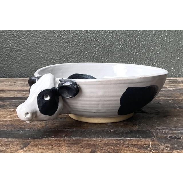 This charming vintage studio pottery bowl is a whimsical masterclass in artisanal character and sculptural form. Hand-...