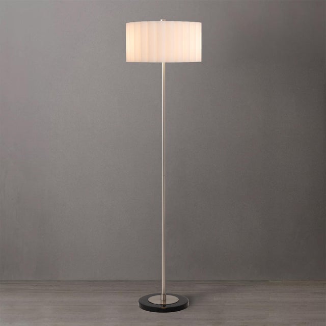 The Slimline Floor Lamp is a modern floor lamp featuring a sleek satin Nickel steel body and base, complemented by a white...