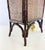 A striking vintage table lamp crafted with a dark bamboo frame surrounding tightly woven rattan panels. The tall...