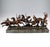Excellent piece of viennese bronze art around 1920: five native americans in war dress, armed with rifles, axes and...