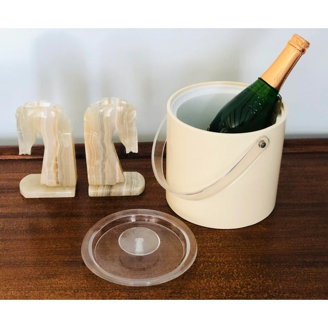 A vintage modern looking ice bucket wine cooler design by Gorges Briard. With lucite handle and top.