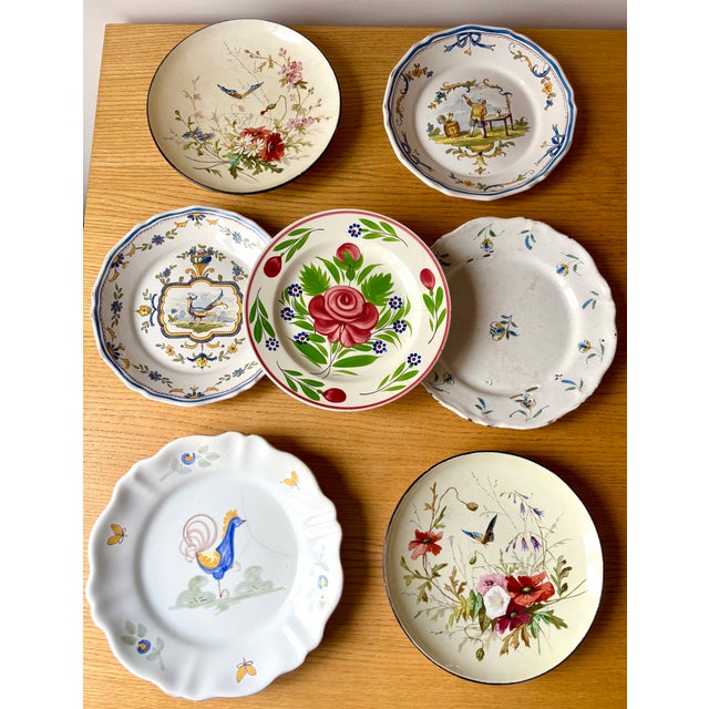 A rare and elegant set of seven antique plates dating from the late 18th to early 20th century, showcasing the refined...