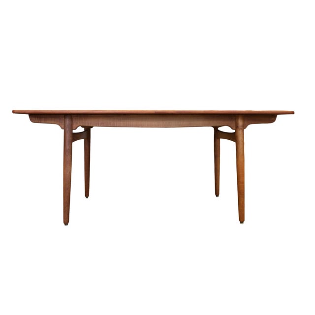 An iconic dining table in the at 310 model, designed by hans j. Wegner and manufactured by the well-respected furniture...
