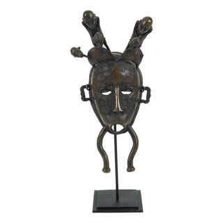 Ivory Coast Senufo Kpelie Cast Bronze Baul Mask Depicting Tribesmen on Stand For Sale