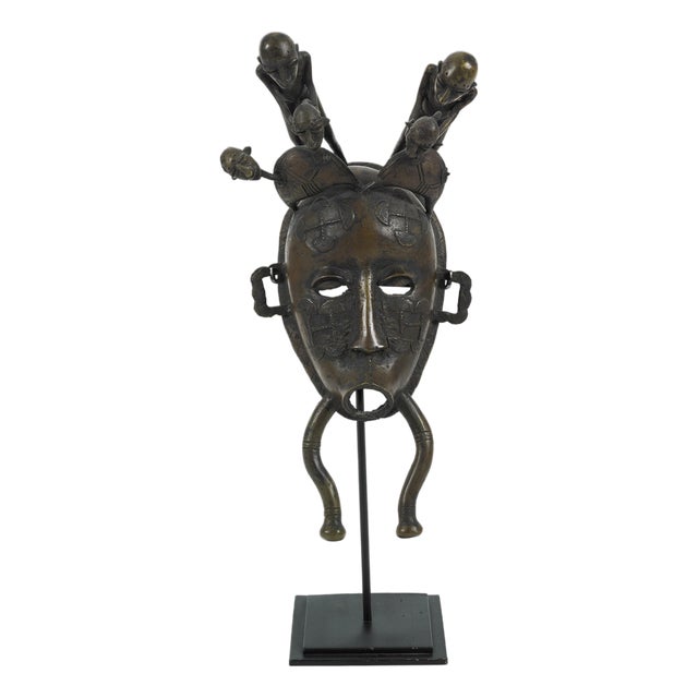Ivory Coast Senufo Kpelie Cast Bronze Baul Mask Depicting Tribesmen on Stand For Sale