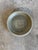 This striking studio pottery bowl showcases a rich, mossy olive green glaze with a beautifully speckled, textured finish....