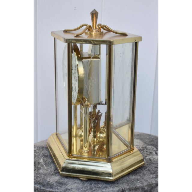Vintage (1990's) Clock has a Hexagon Shape. The Brand: Welby, Kieninger and Obergfell. The Clock is made of Brass, Glass,...