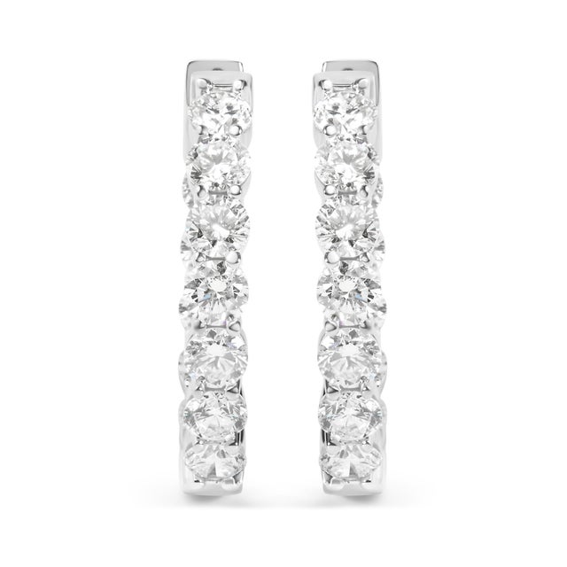 Immerse yourself in the radiance of these 14K white gold hoop earrings, where elegance meets modern technology. Rhodium-...