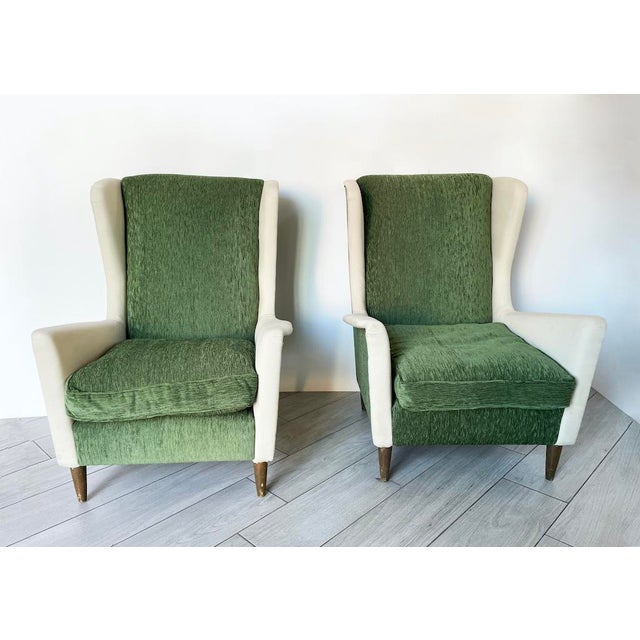 This elegant pair of two-tone mid-century armchairs features a slender frame with a high, enveloping backrest. Upholstered...