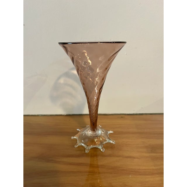 Lovely pink vase with a swirl motif on the body. Clear sunburst footing with a pontil mark on the bottom, indicating the...