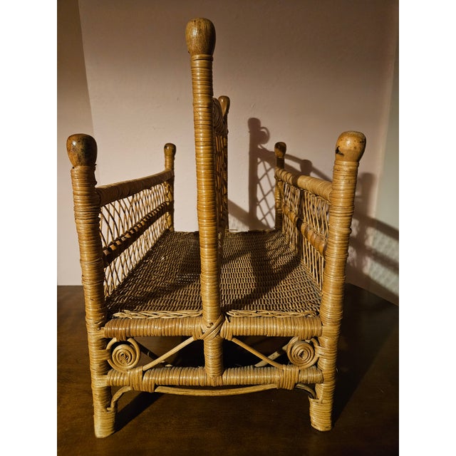 American Victorian highly ornate wicker magazine rack, featuring beaded accents and finials. This vintage footed magazine...