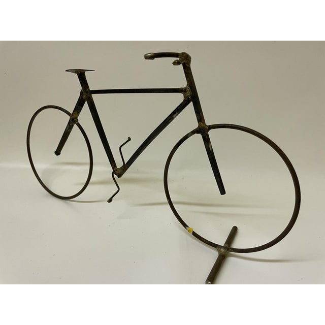 This handcrafted tabletop bicycle sculpture brings an elegant layer of vintage industrial character to any mid-century...