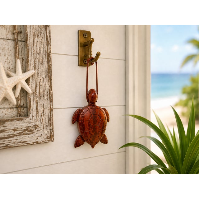 Charming hand-carved wooden sea turtle featuring a dimensional carved shell and warm reddish-brown finish. Inspired by the...