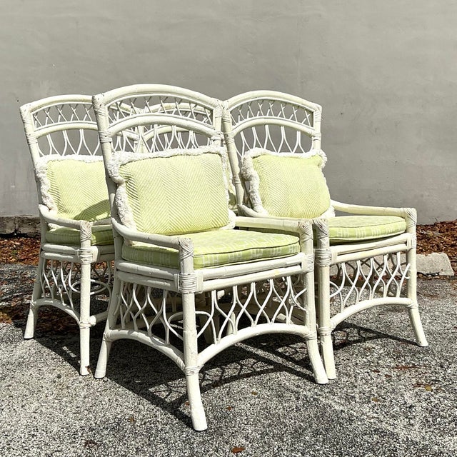 Set of 4 vintage coastal trellis rattan dining chairs, designed with a beautiful woven trellis pattern that brings a...