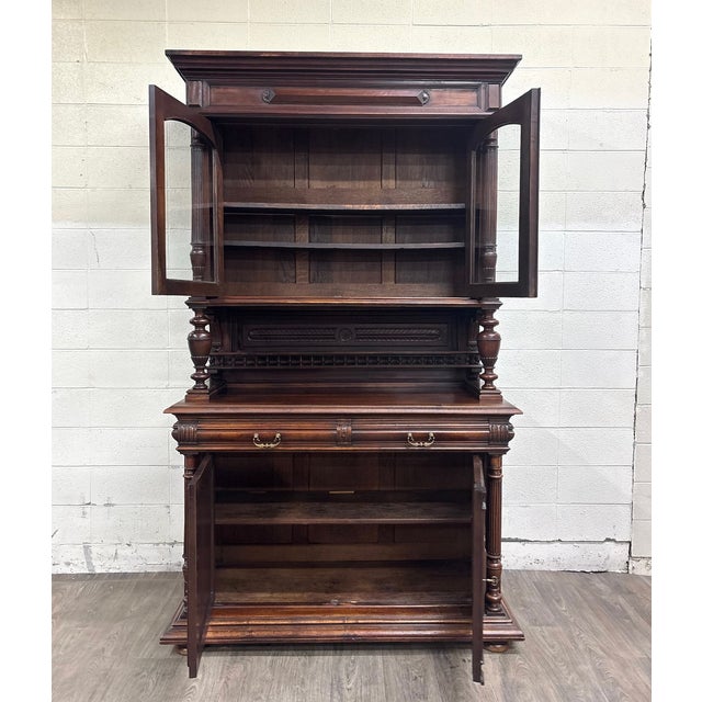 This is an impressive antique late 19th-century French Renaissance Revival walnut step-back bookcase cabinet, circa 1880....