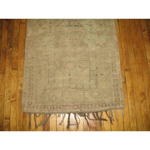 A midcentury one of a kind Moroccan runner with light cream and pink accents, circa 1940. Measures: 2'10" x 9'7".