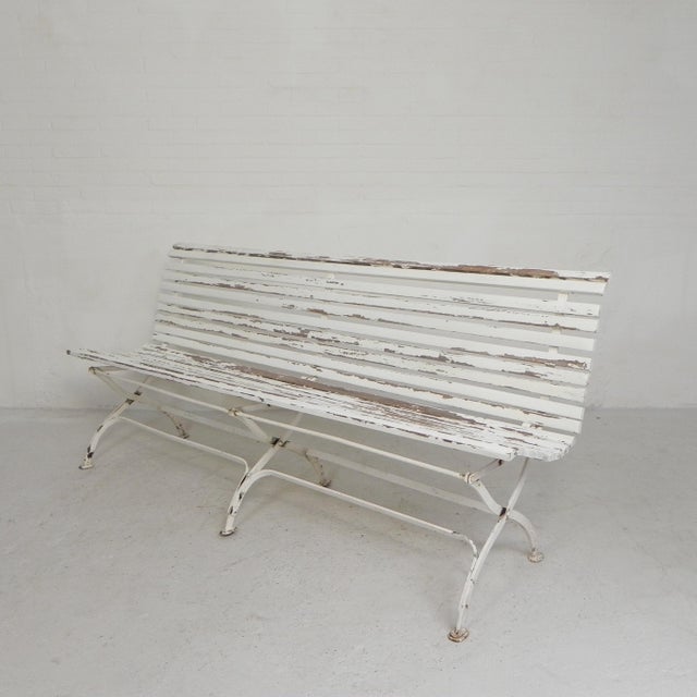 This bench features a curved ergonomic backrest, wooden slats, and elegant steel legs. For storage, the bench can be...