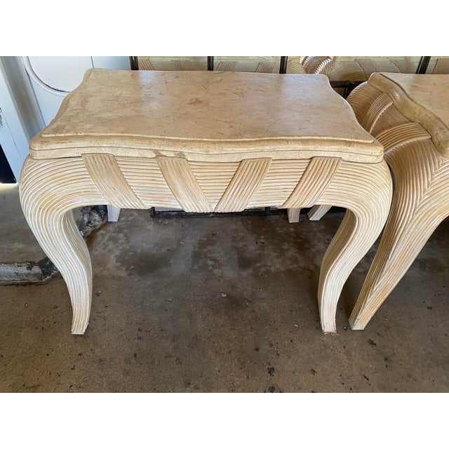 -Light washed rattan -Intricately wrapped rattan and curved legs -Beveled travertine slab top -Postmodern -Sold as a pair...
