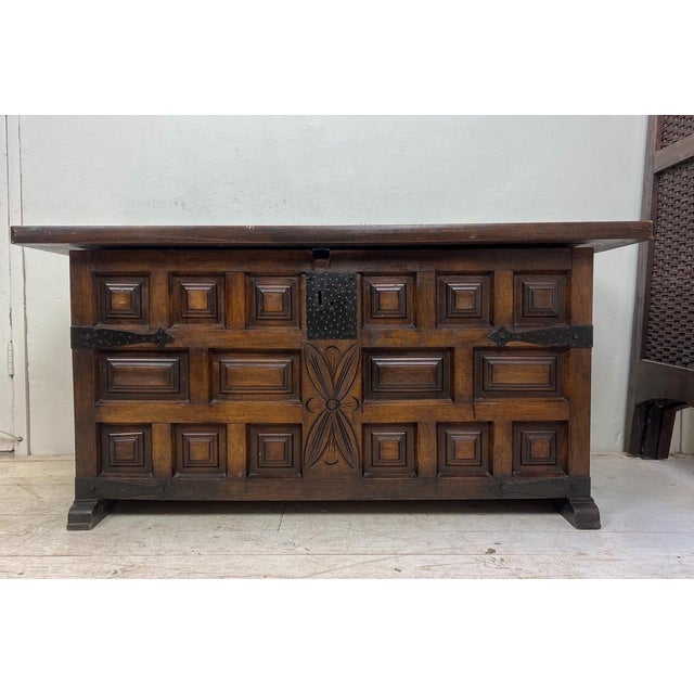 20th Spanish carved walnut wood blanket chest with raised wooden panels and original iron hardware ca 1950. This old trunk...