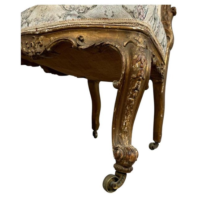 Immerse yourself in the elegance of 19th-century French decorative arts with this exceptional antique giltwood armchair,...